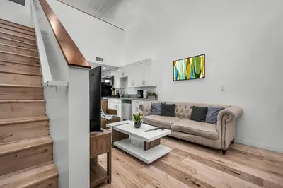 a living room with a couch and a table at Modern 1-Bedroom Loft in Hollywood with Parking, WiFi & Hollywood Sign View in Los Angeles