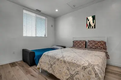 a bedroom with a bed and a window at Modern 1-Bedroom Loft in Hollywood with Parking, WiFi & Hollywood Sign View in Los Angeles