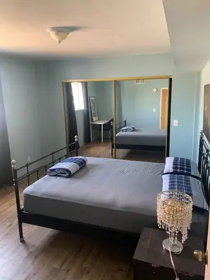 a bedroom with a bed with a large mirror at LA Love Home in Los Angeles