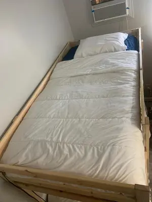 a bed frame in a corner of a room at LA Love Home in Los Angeles