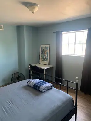 a bedroom with a bed and a desk and a window at LA Love Home in Los Angeles