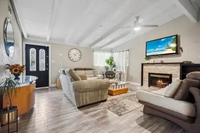 a living room with a couch and a fireplace at The Perfect Vacation Spot Near Six Flags Magic Mountain in Santa Clarita