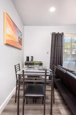 a dining room with a table and chairs at Deluxe Modern 2BR Apt in Prime Location in Los Angeles