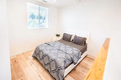 a bedroom with a bed and a window at Chic Modern Loft in Hollywood 1 Bedroom with Balcony & Free Secure Parking in Los Angeles