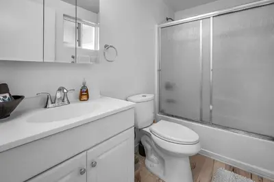 a white bathroom with a toilet and a shower at Chic Modern Loft in Hollywood 1 Bedroom with Balcony & Free Secure Parking in Los Angeles