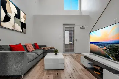 a living room with a couch and a tv at Chic Modern Loft in Hollywood 1 Bedroom with Balcony & Free Secure Parking in Los Angeles
