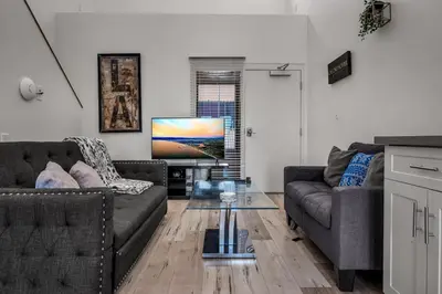 a living room with two couches and a television at Stylish Modern one Bedroom Hollywood Loft With in unite washer dryer & Balcony in Los Angeles