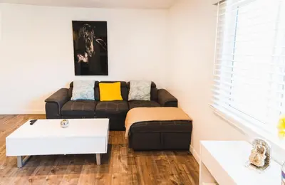 a living room with a couch and a table at Chic Large 1 Bedroom Apartment in Koreatown with Dining Area Free Gated Parking in Los Angeles