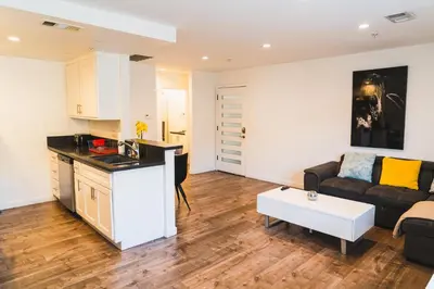 a kitchen and living room with a couch and a table at Chic Large 1 Bedroom Apartment in Koreatown with Dining Area Free Gated Parking in Los Angeles
