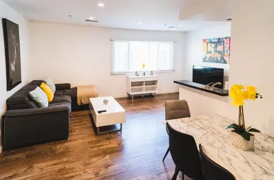 a living room with a couch and a table at Chic Large 1 Bedroom Apartment in Koreatown with Dining Area Free Gated Parking in Los Angeles