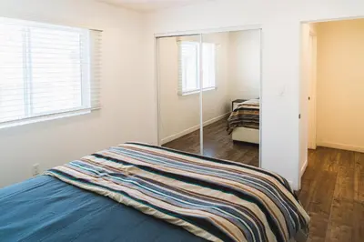 a bedroom with a bed and a mirror at Chic Large 1 Bedroom Apartment in Koreatown with Dining Area Free Gated Parking in Los Angeles