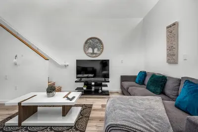 a living room with a couch and a table at 1-Bedroom Lofts in Hollywood Modern Design, Balcony, Parking & Hollywood Sign in Los Angeles