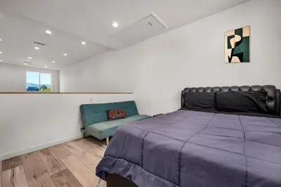 a bedroom with a bed and a couch and a window at 1-Bedroom Lofts in Hollywood Modern Design, Balcony, Parking & Hollywood Sign in Los Angeles