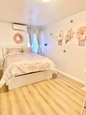 a bedroom with a bed with flowers on the wall at Pink Cozy house 2 bedrooms in Rosemead