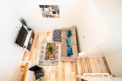 a living room with a couch and a tv at Nice 2 Bedroom 3 Level Loft in Central Location Close to Downtown LA Free Gated Parking Full Kitchen in Los Angeles