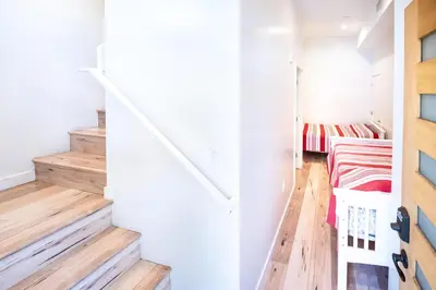 a room with stairs leading up to a bedroom at Nice 2 Bedroom 3 Level Loft in Central Location Close to Downtown LA Free Gated Parking Full Kitchen in Los Angeles