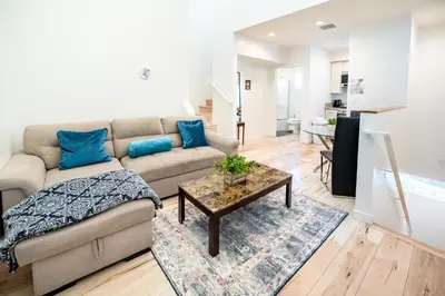 a living room with a couch and a table at Nice 2 Bedroom 3 Level Loft in Central Location Close to Downtown LA Free Gated Parking Full Kitchen in Los Angeles