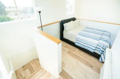 a small room with a bed and a window at Unique 3-Level Loft with One bedroom & Two Full Bathroom in Los Angeles