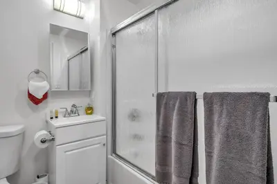 a bathroom with a shower and a toilet and a sink at Chic 2 Bedroom 2 Bathroom 3 Level Loft Style Condo by Hollywood Free Gated Parking Full kitchen in Los Angeles