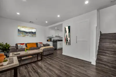 a living room with a couch and a table at Modern 2 Levels One-Bedroom Retreat in central Location in Hollywood in Los Angeles