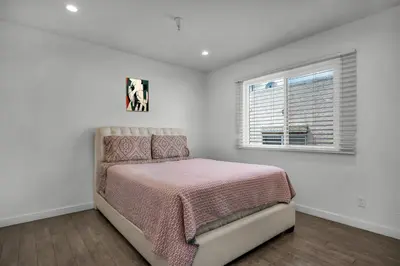 a white bedroom with a bed and a window at Fully Furnished 1 Bedroom Apartment with Full Bathroom in Koreatown Free Gated Parking Full Kitchen in Los Angeles