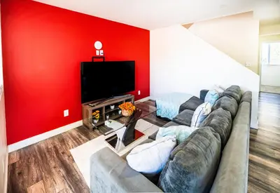 a living room with a couch and a flat screen tv at Spacious 5 Bedroom 3 Bath Home for Large Groups By DT LA in Los Angeles