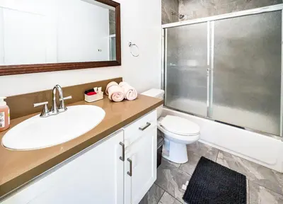 a bathroom with a sink and a toilet and a shower at Spacious 5 Bedroom 3 Bath Home for Large Groups By DT LA in Los Angeles
