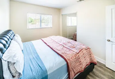 a bedroom with a bed with a blanket on it at Spacious 5 Bedroom 3 Bath Home for Large Groups By DT LA in Los Angeles