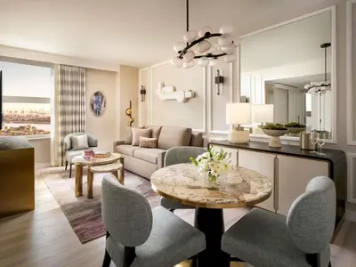 a living room with a table and chairs at Fairmont Breakers Long Beach in Long Beach