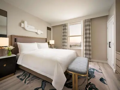 a bedroom with a large white bed and a window at Fairmont Breakers Long Beach in Long Beach
