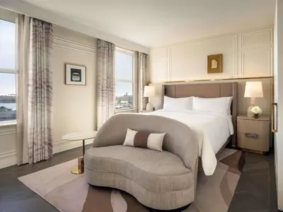a hotel room with a bed and a chair at Fairmont Breakers Long Beach in Long Beach