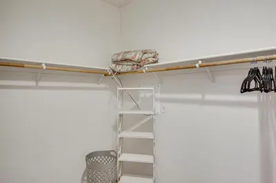 a shelf in a room with a ladder and umbrellas at Rio Bravo Country Club Home in Bakersfield with Pool in Bakersfield