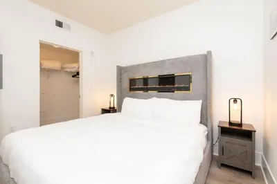 a bedroom with a large white bed and a closet at The Modern Suite Residences in Glendale