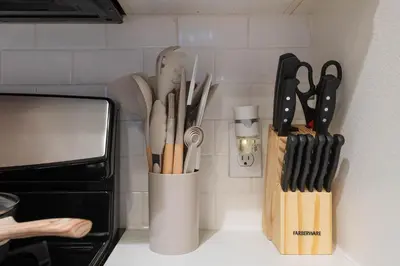 a knife block filled with utensils on a kitchen counter at The Modern Suite Residences in Glendale
