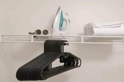 a black bench in a room with a computer on a shelf at The Modern Suite Residences in Glendale