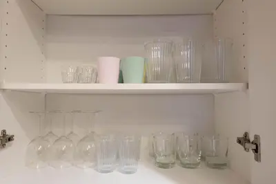 a bunch of glasses sitting on a shelf at The Modern Suite Residences in Glendale