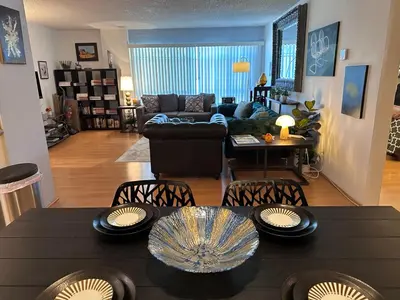 a living room with a black table and chairs at Beverly Estates in Los Angeles