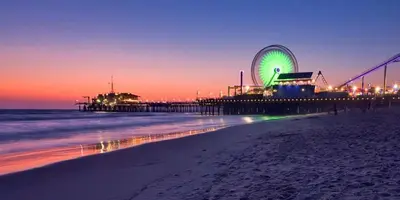 a beach with a pier and a ferris wheel at night at Brand New Studio in Mar Vista in Los Angeles