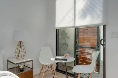 a living room with a table and chairs and a window at Brand New Studio in Mar Vista in Los Angeles