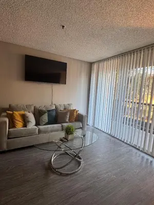 a living room with a couch and a glass table at Loft & Two Bedroom Hollywood apartments FREE Parking in Los Angeles