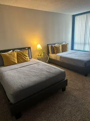 a room with two beds and a lamp in it at Loft & Two Bedroom Hollywood apartments FREE Parking in Los Angeles