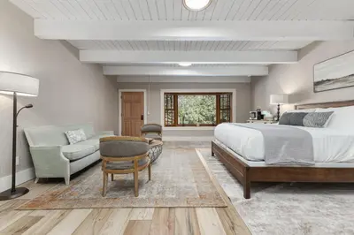 a bedroom with a bed and a couch and a chair at Big Pine Suite CN Lodge R#1 in Ponderosa