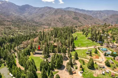 an aerial view of a park with trees and mountains at Big Pine Suite CN Lodge R#1 in Ponderosa