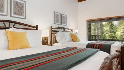 a bedroom with two beds and a window at Suite Meadow @CN Lodge# 7 in Ponderosa