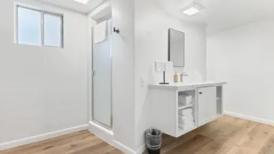 a white bathroom with a sink and a mirror at Camp Nelson Lodge Room 6 in Ponderosa