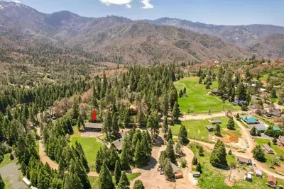 an aerial view of a park with trees and mountains at Camp Nelson Lodge Room 6 in Ponderosa