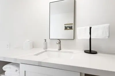 a white bathroom with a sink and a mirror at Timberline Retreat CN Lodge #3 in Ponderosa