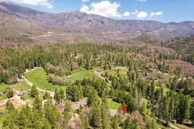 an aerial view of a forest with mountains in the background at Timberline Retreat CN Lodge #3 in Ponderosa