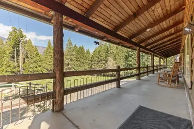 a large porch with a view of the mountains at Camp Nelson Lodge Room 10 in Ponderosa