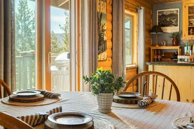 a table with plates and bowls on it in a kitchen at Little Lakeview Lodge in Big Bear Lake